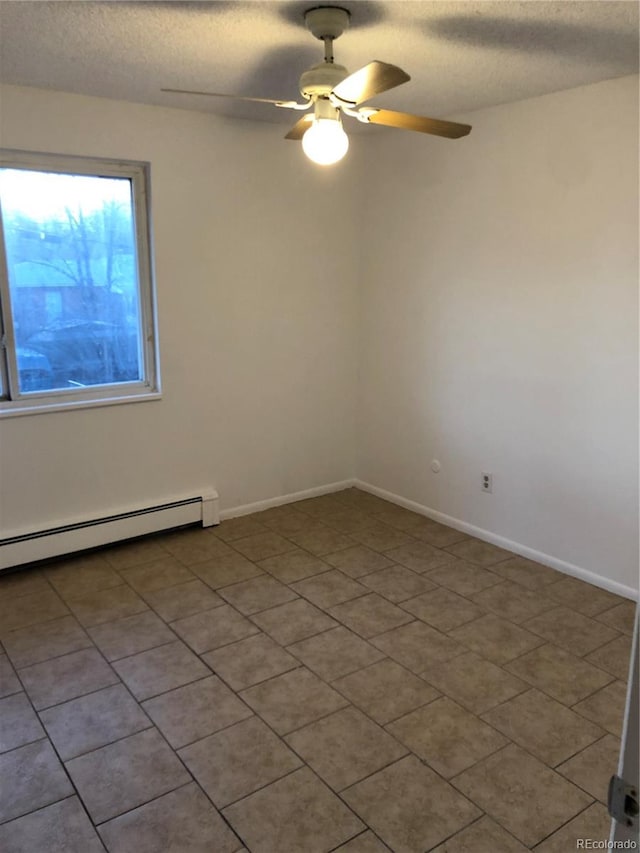 tiled empty room featuring a textured ceiling, ceiling fan, and a baseboard heating unit