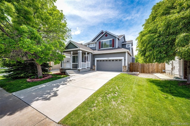 5794 S Yakima Way, Aurora, CO 80015 - view of front of house with a garage, concrete driveway, stone siding, and a porch