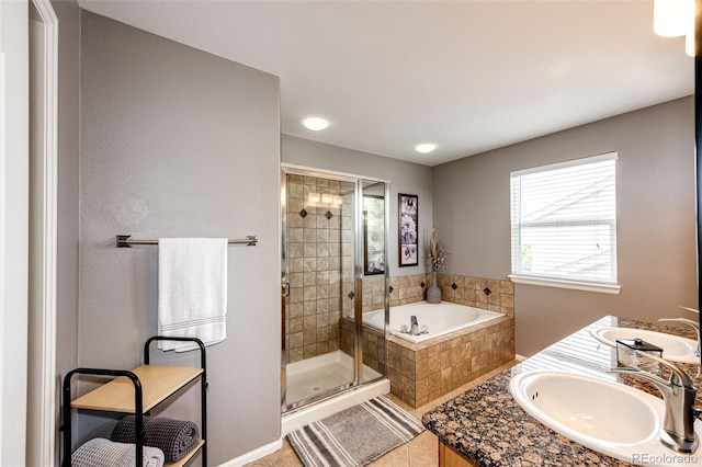 5794 S Yakima Way, Aurora, CO 80015 - bathroom featuring a bath, a shower stall, tile patterned flooring, and double vanity