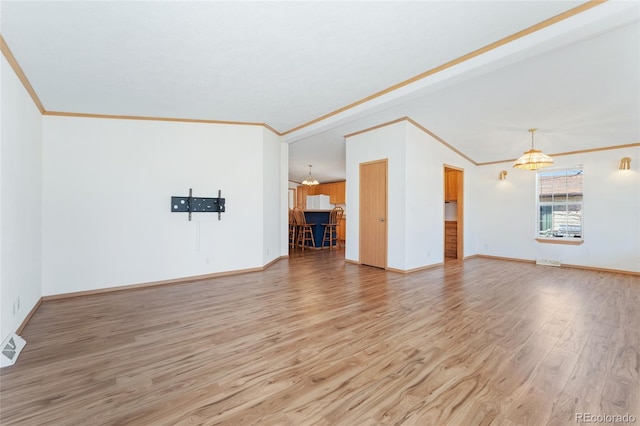 2019 S Fox St, Denver, CO 80223 - unfurnished living room featuring ornamental molding, a chandelier, and light wood-type flooring