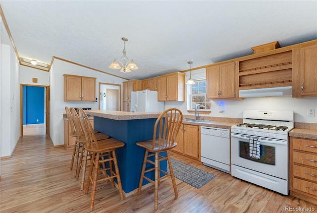 2019 S Fox St, Denver, CO 80223 - kitchen with white appliances, vaulted ceiling, a kitchen island, under cabinet range hood, and light wood finished floors