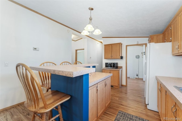 2019 S Fox St, Denver, CO 80223 - kitchen featuring stainless steel microwave, a breakfast bar, light countertops, a chandelier, and crown molding