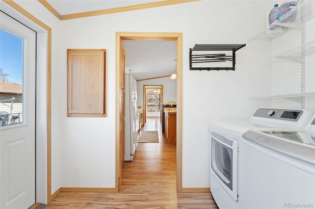 2019 S Fox St, Denver, CO 80223 - laundry area featuring washer and clothes dryer, light wood-style floors, and crown molding