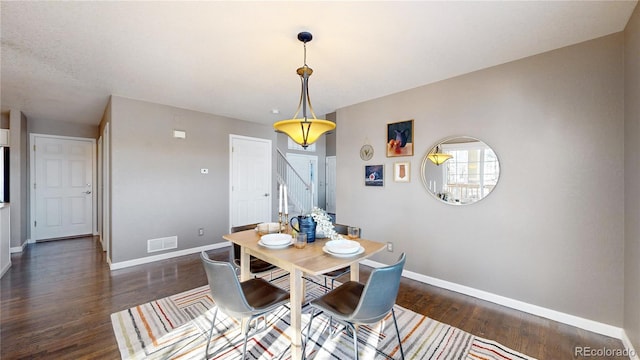 dining room with dark hardwood / wood-style flooring