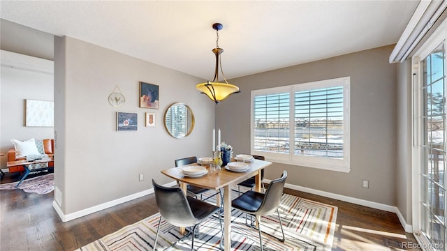 dining area with dark hardwood / wood-style floors