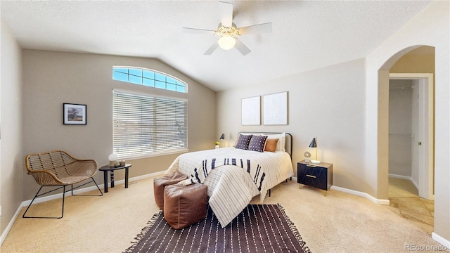 carpeted bedroom with ceiling fan and lofted ceiling