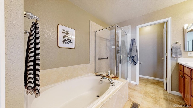 bathroom with tile patterned flooring, a textured ceiling, vanity, and separate shower and tub