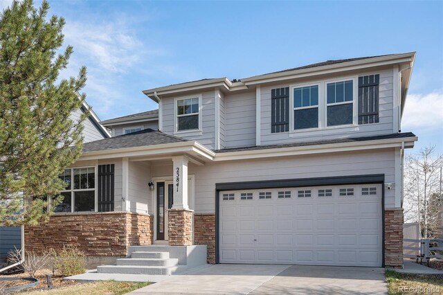 23841 E Alabama Dr, Aurora, CO 80018 - view of front of home with a garage, driveway, and stone siding