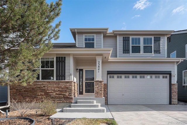 23841 E Alabama Dr, Aurora, CO 80018 - view of front of home with a garage, concrete driveway, and stone siding