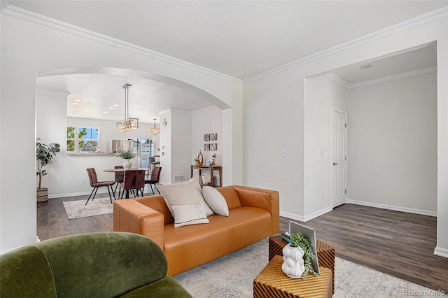 23841 E Alabama Dr, Aurora, CO 80018 - living area with arched walkways, wood finished floors, baseboards, ornamental molding, and a chandelier