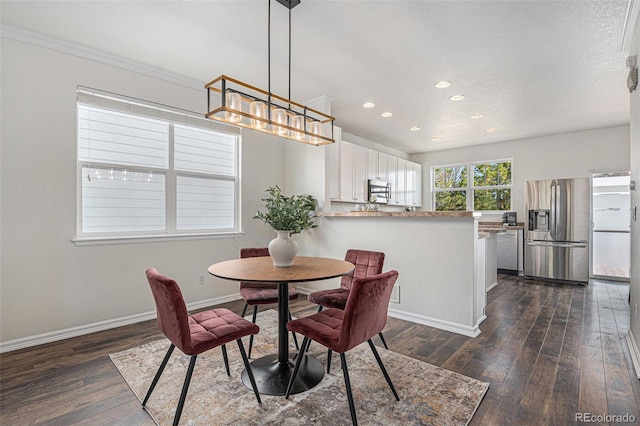 23841 E Alabama Dr, Aurora, CO 80018 - dining area with recessed lighting, dark wood finished floors, baseboards, and crown molding
