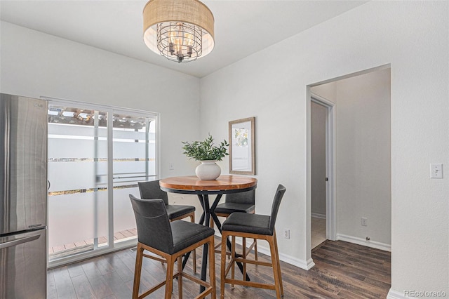 23841 E Alabama Dr, Aurora, CO 80018 - dining room featuring wood finished floors, a chandelier, and baseboards