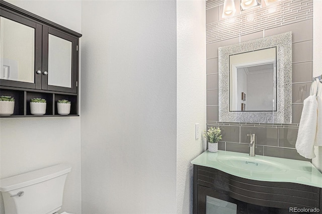 23841 E Alabama Dr, Aurora, CO 80018 - half bathroom with toilet, tasteful backsplash, and vanity
