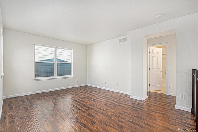 23841 E Alabama Dr, Aurora, CO 80018 - empty room featuring dark wood-style flooring, baseboards, and a smoke detector