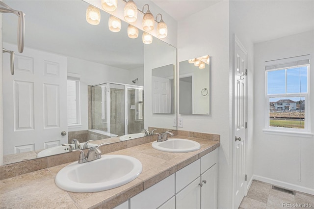 23841 E Alabama Dr, Aurora, CO 80018 - full bath with a stall shower, double vanity, and baseboards