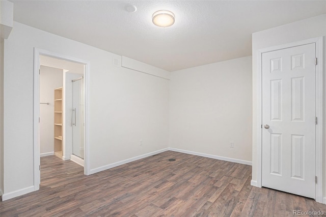 23841 E Alabama Dr, Aurora, CO 80018 - unfurnished room with wood finished floors, baseboards, and a textured ceiling