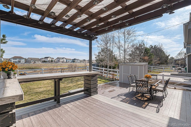 23841 E Alabama Dr, Aurora, CO 80018 - deck with a storage unit, a pergola, an outbuilding, outdoor dining area, and a residential view