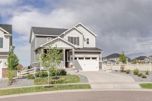 craftsman-style home featuring fence, driveway, an attached garage, board and batten siding, and a residential view