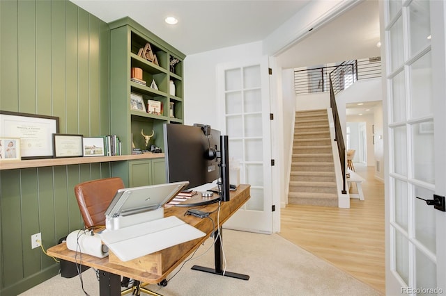 home office featuring french doors, recessed lighting, wood finished floors, and built in shelves