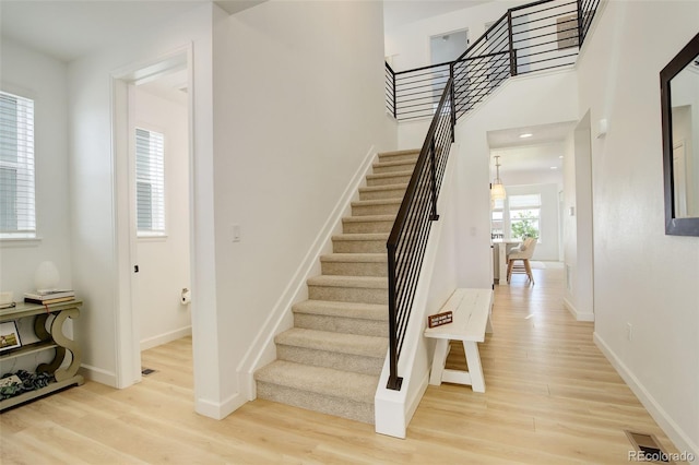 stairs featuring wood finished floors and baseboards