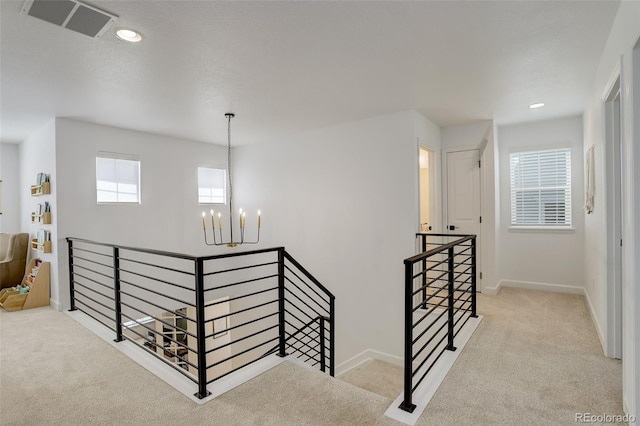 stairs with a chandelier, carpet floors, baseboards, and recessed lighting