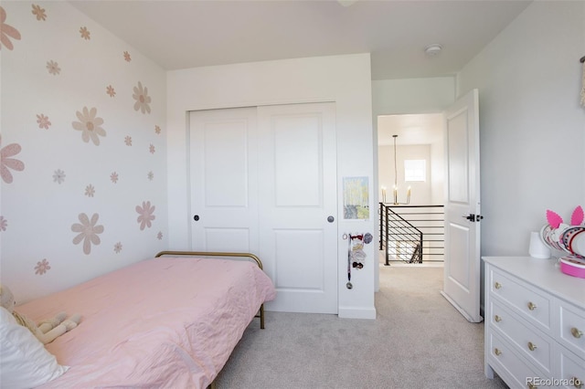 bedroom with carpet floors, a closet, and wallpapered walls
