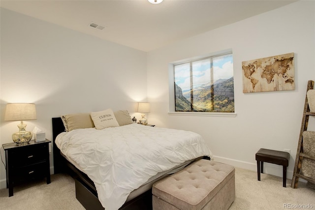 bedroom featuring light carpet and baseboards