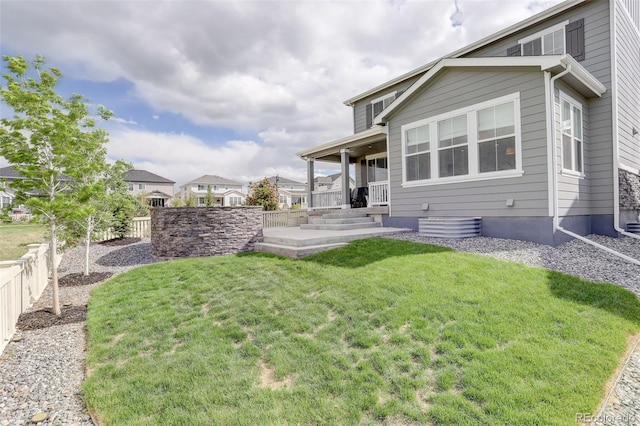 back of property with a porch and a residential view
