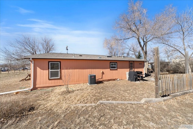 back of property with fence and central AC unit