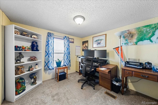 home office featuring a textured ceiling, carpet, and visible vents