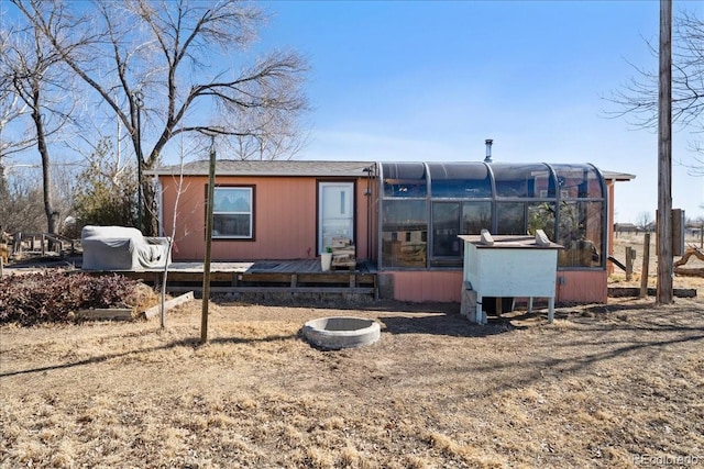 back of property with an outdoor structure