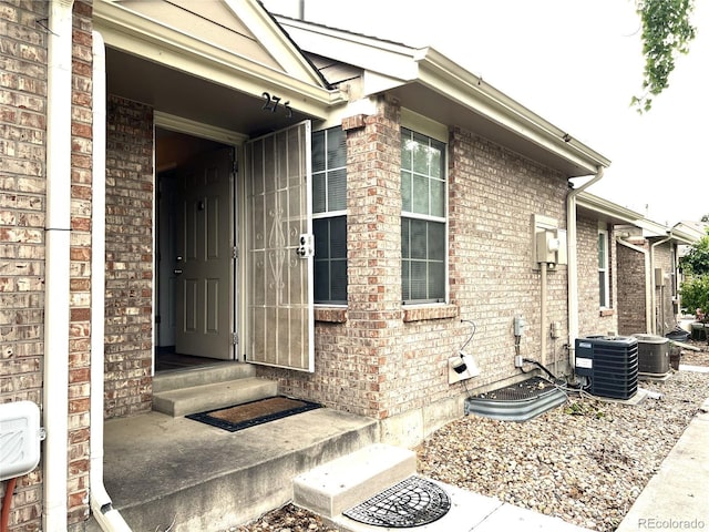 1470 S Quebec Way Unit 275, Denver, CO 80231 - doorway to property with brick siding and cooling unit