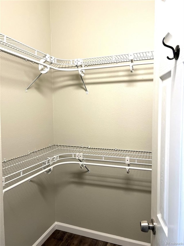 1470 S Quebec Way Unit 275, Denver, CO 80231 - walk in closet featuring dark wood-style flooring