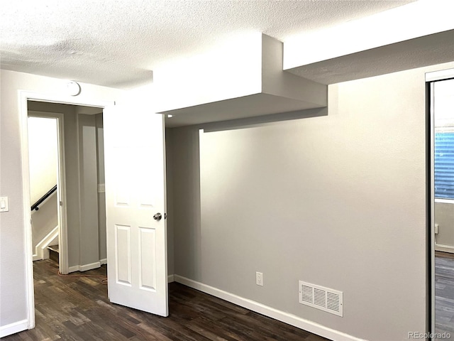 1470 S Quebec Way Unit 275, Denver, CO 80231 - unfurnished bedroom with dark wood-style flooring, baseboards, and a textured ceiling