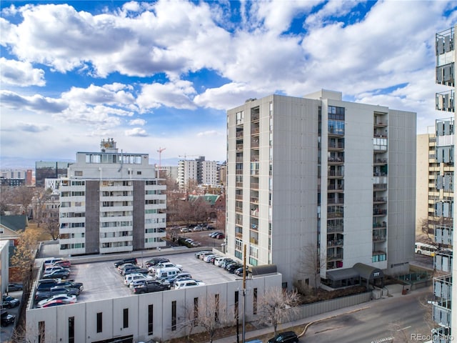 view of property with a view of city and uncovered parking