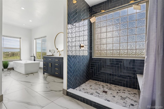 full bath featuring a soaking tub, vanity, recessed lighting, a tile shower, and marble finish flooring