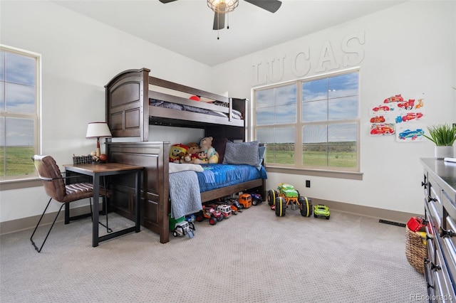 bedroom featuring light carpet, baseboards, and ceiling fan