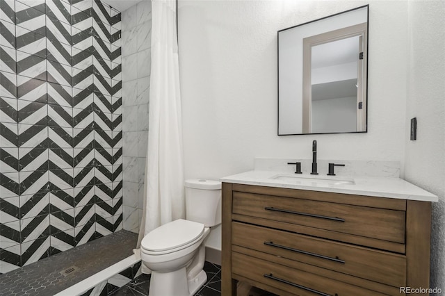 full bathroom featuring toilet, vanity, and a shower stall