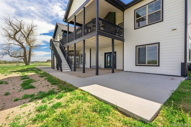 back of house featuring a patio and stairway