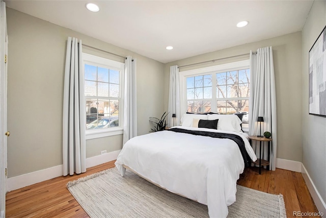 bedroom featuring light wood-type flooring, baseboards, and recessed lighting