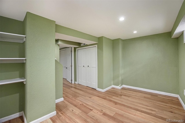 interior space with baseboards, recessed lighting, and light wood-style floors