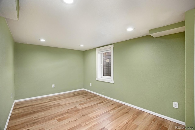 unfurnished room featuring light wood-type flooring, baseboards, and recessed lighting