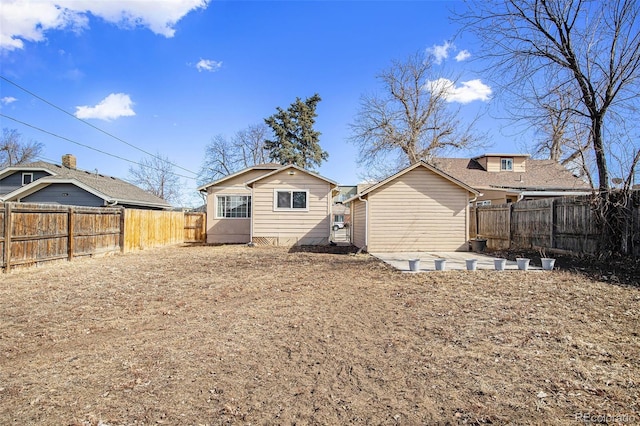 rear view of house with a patio area and a fenced backyard