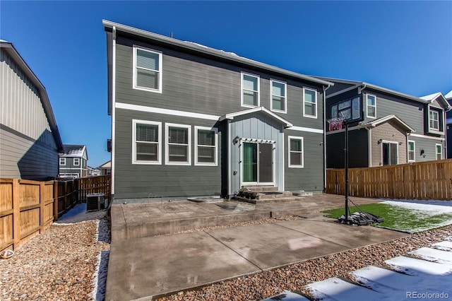 rear view of house featuring a fenced backyard, cooling unit, entry steps, and a patio