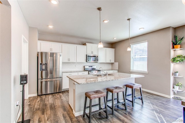 kitchen featuring dark wood-style floors, backsplash, appliances with stainless steel finishes, and white cabinets