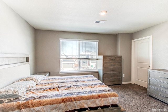 bedroom with visible vents, baseboards, and dark colored carpet