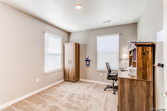 office with visible vents, baseboards, and carpet