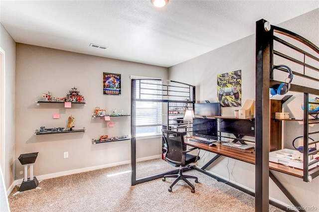 carpeted office space featuring baseboards, visible vents, and a textured ceiling