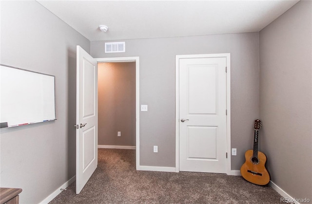 unfurnished bedroom featuring visible vents, carpet floors, and baseboards