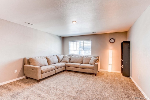 living room with baseboards, light colored carpet, visible vents, and a textured ceiling